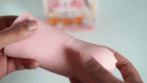GIF of PercyOna stretching Puni Fuwa Mafia Super Soft Double Layer / ぷにふわマフィア極柔二層 onahole in a review to show its soft, elastic material by RideJapan.